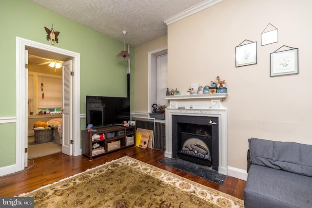 living room with dark hardwood / wood-style floors and a textured ceiling