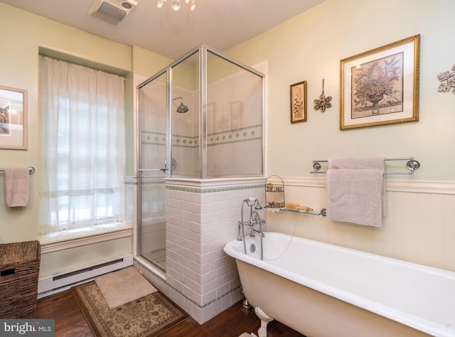 bathroom featuring plus walk in shower, hardwood / wood-style floors, and a baseboard heating unit