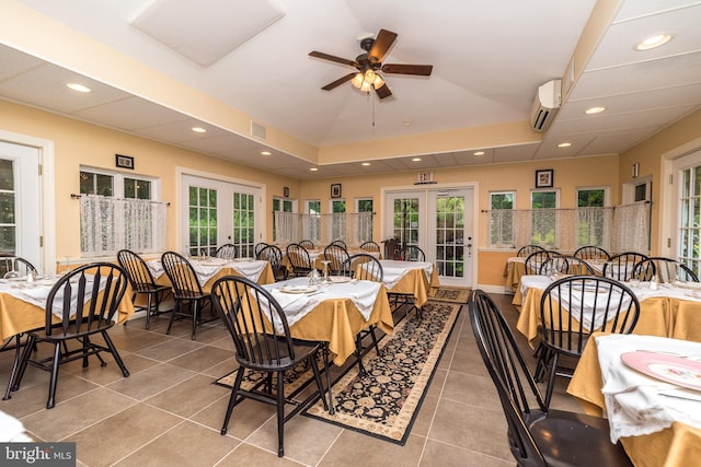 dining area featuring ceiling fan, french doors, light tile patterned floors, and a wall mounted air conditioner