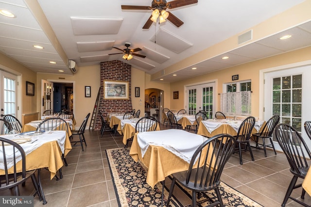 dining area featuring french doors, lofted ceiling, tile patterned floors, and plenty of natural light