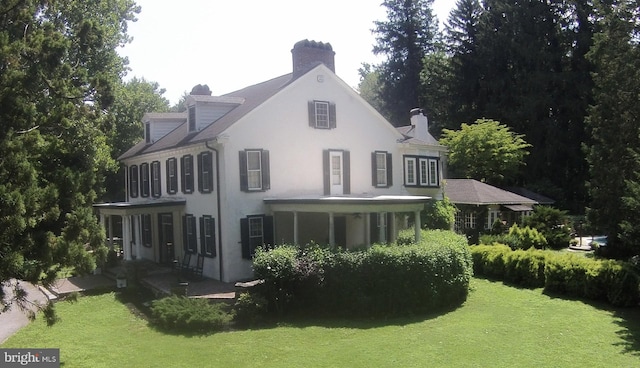 rear view of property with a yard