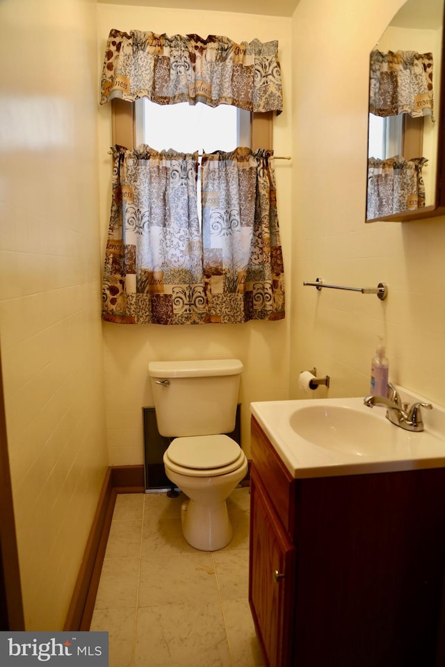 bathroom featuring tile patterned floors, vanity, and toilet