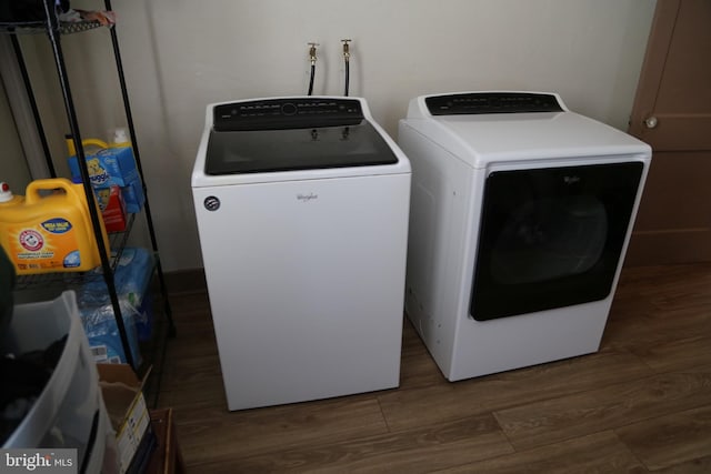 laundry area featuring washer and dryer and hardwood / wood-style flooring