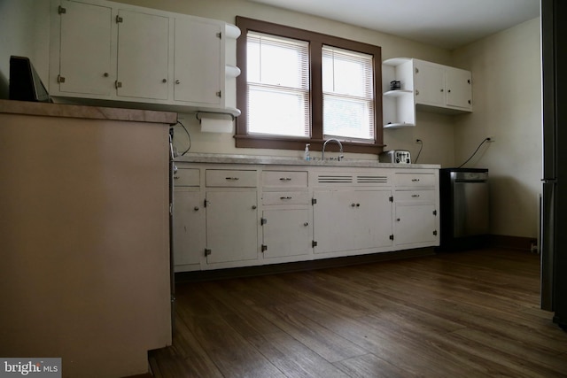 kitchen featuring sink, dark wood-type flooring, fridge, and white cabinetry