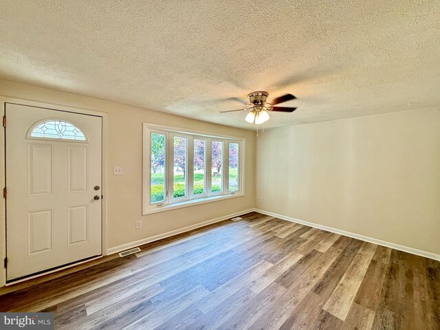 entrance foyer with a textured ceiling, ceiling fan, and hardwood / wood-style floors