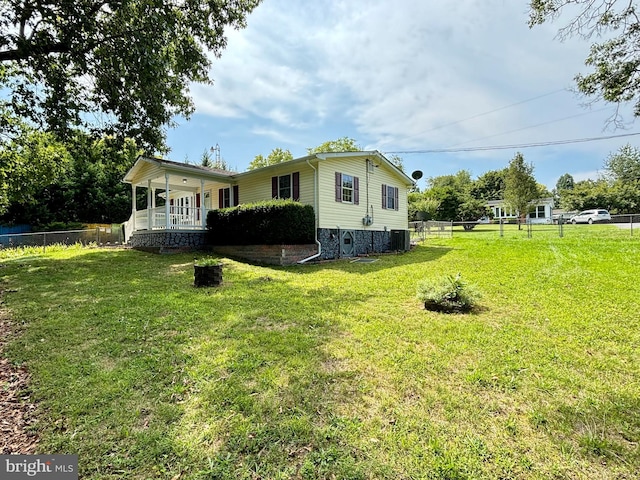 view of property exterior featuring a yard, central AC, and fence