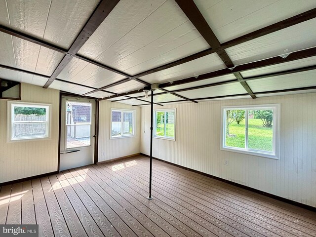 interior space with beam ceiling and hardwood / wood-style floors