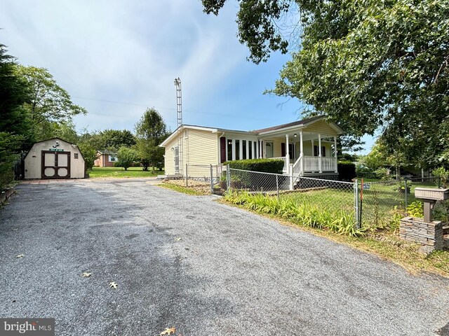 view of front of house with an outbuilding and a porch