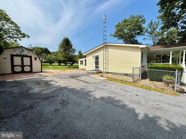 view of home's exterior featuring a storage unit