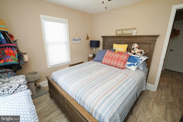 bedroom featuring baseboards and wood finished floors