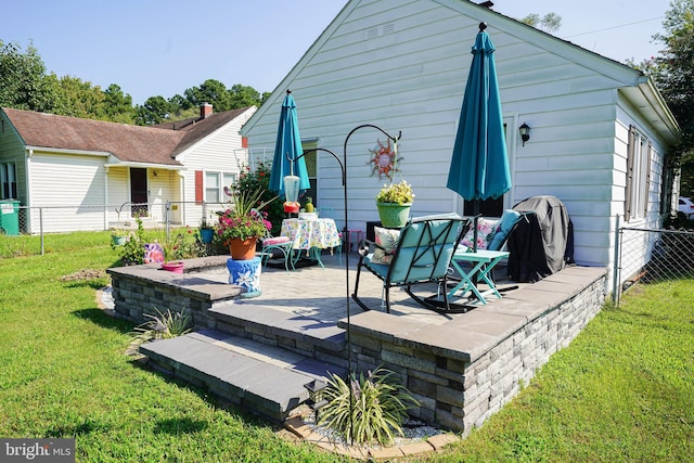 back of property with a patio area and a yard