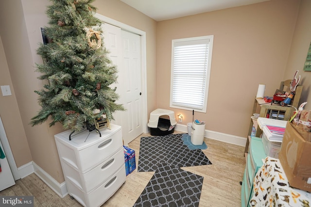 game room featuring light wood-style flooring and baseboards