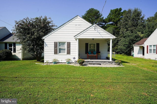 bungalow featuring a porch and a front lawn