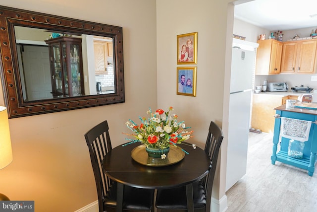 dining room with light wood-type flooring