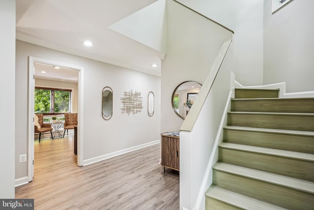 staircase with hardwood / wood-style floors