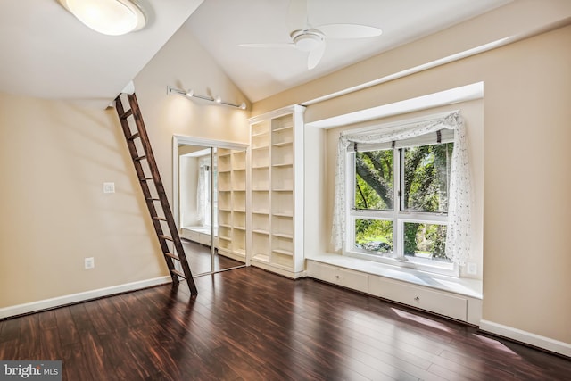 spare room with lofted ceiling, ceiling fan, and dark hardwood / wood-style floors