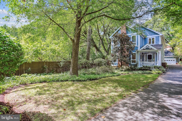 view of front of house featuring a garage and a front lawn