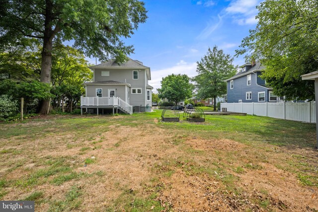 view of side of property with a garage, a lawn, and an outdoor structure