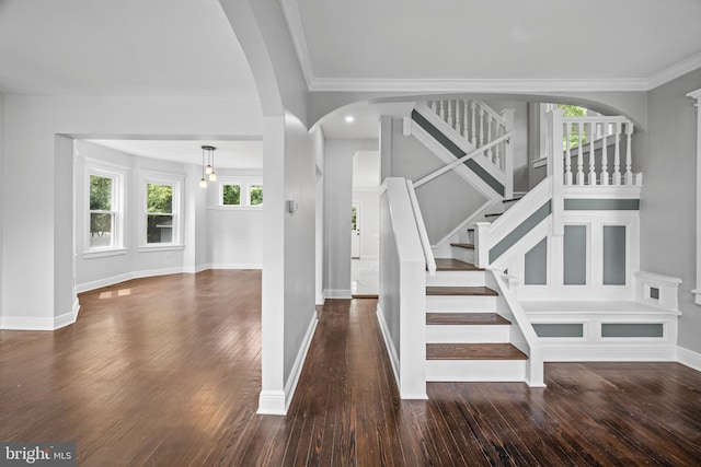 stairs featuring crown molding and hardwood / wood-style floors