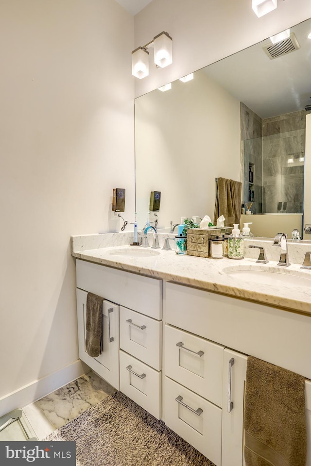 bathroom featuring vanity and an enclosed shower