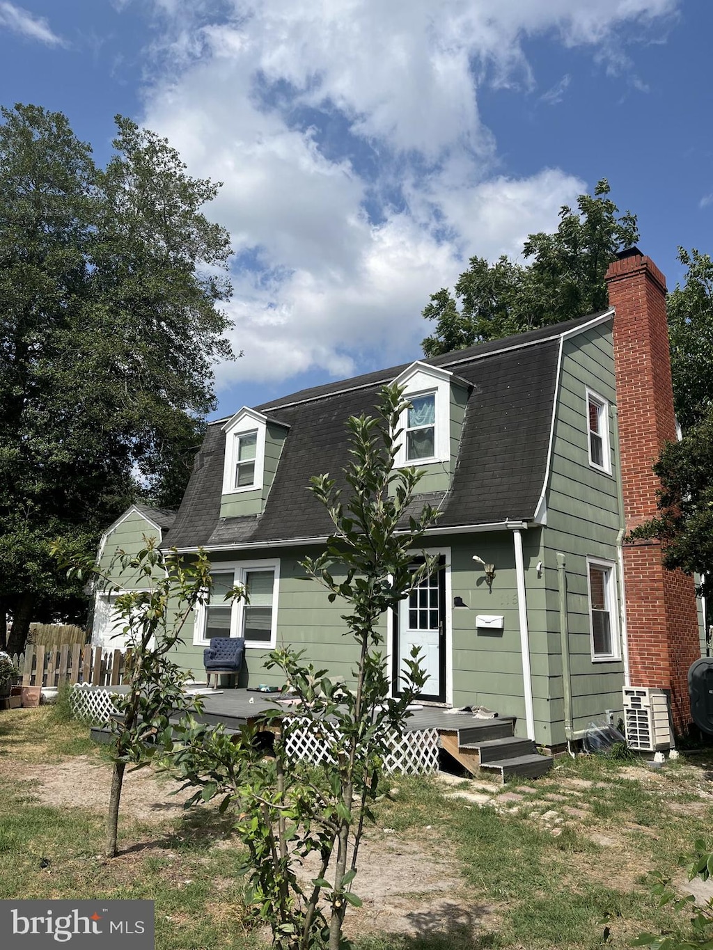 cape cod home featuring central AC unit