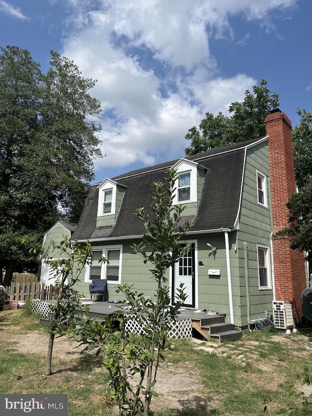 cape cod home featuring central AC unit