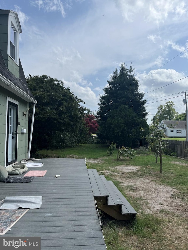 wooden deck with a lawn