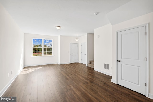 unfurnished room featuring dark wood-type flooring