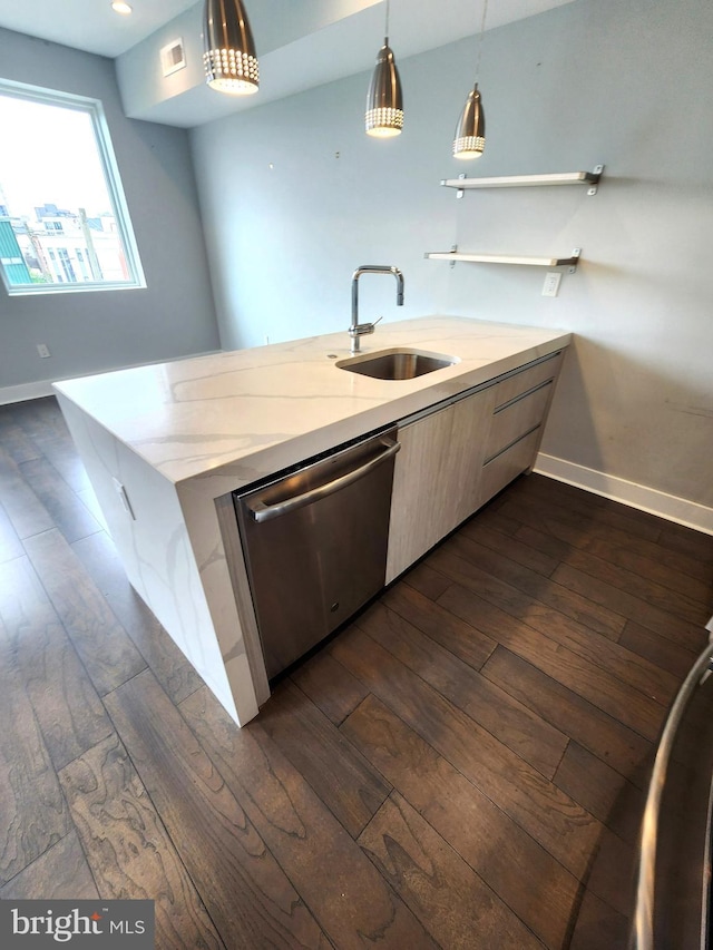 kitchen featuring stainless steel dishwasher, sink, dark hardwood / wood-style floors, and pendant lighting