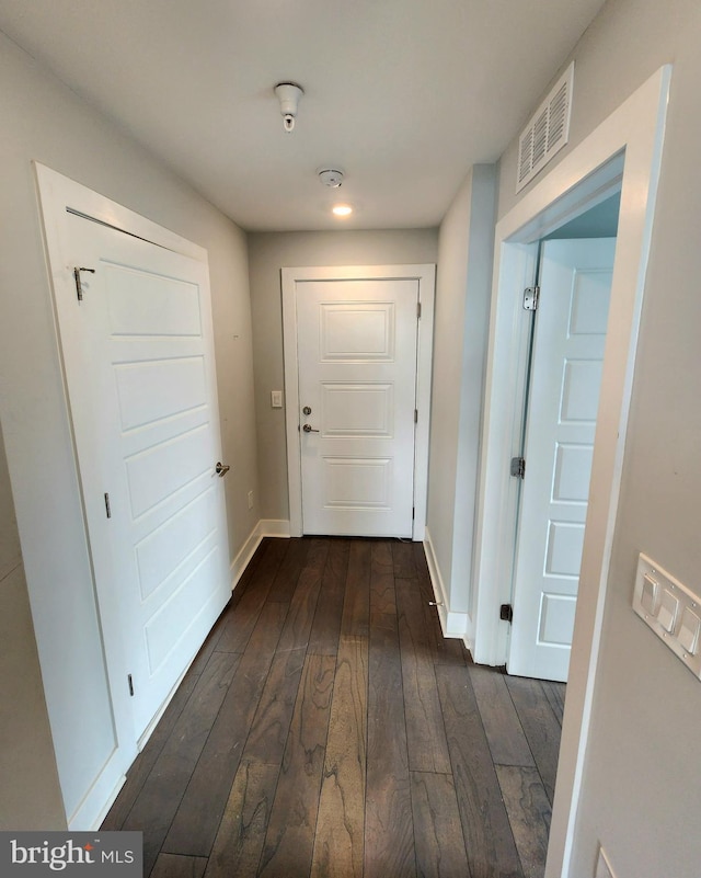 corridor featuring dark hardwood / wood-style floors