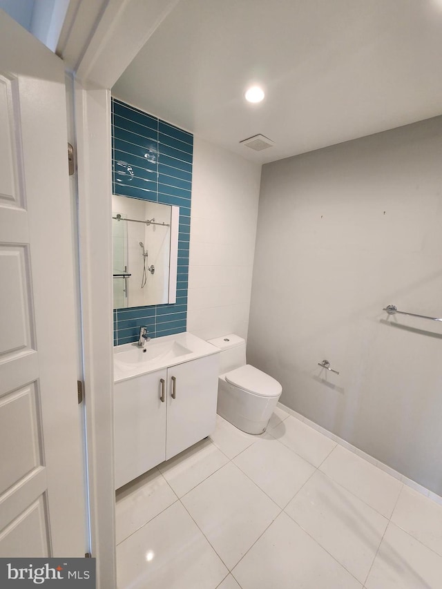 bathroom with vanity, tile patterned floors, and toilet