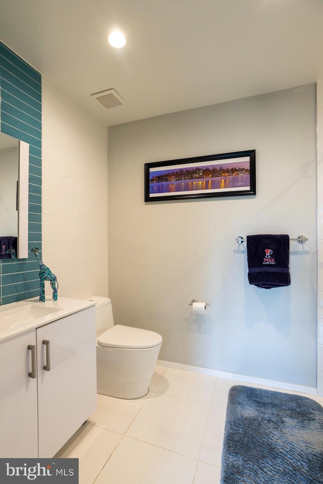 bathroom featuring vanity, tile patterned floors, and toilet