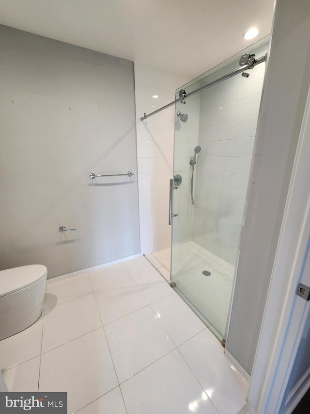 bathroom with toilet, tile patterned floors, and walk in shower