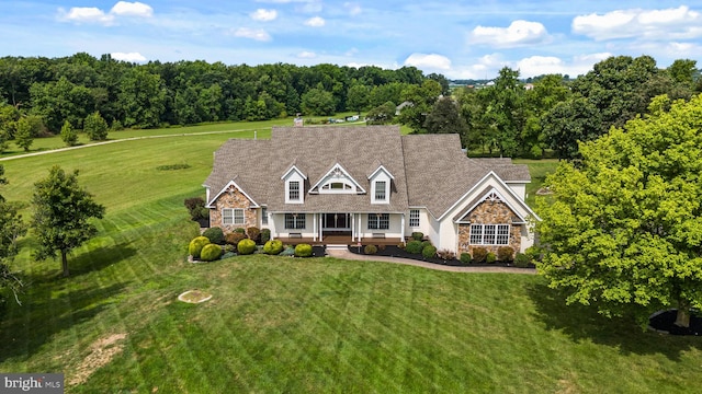 cape cod house with a front lawn