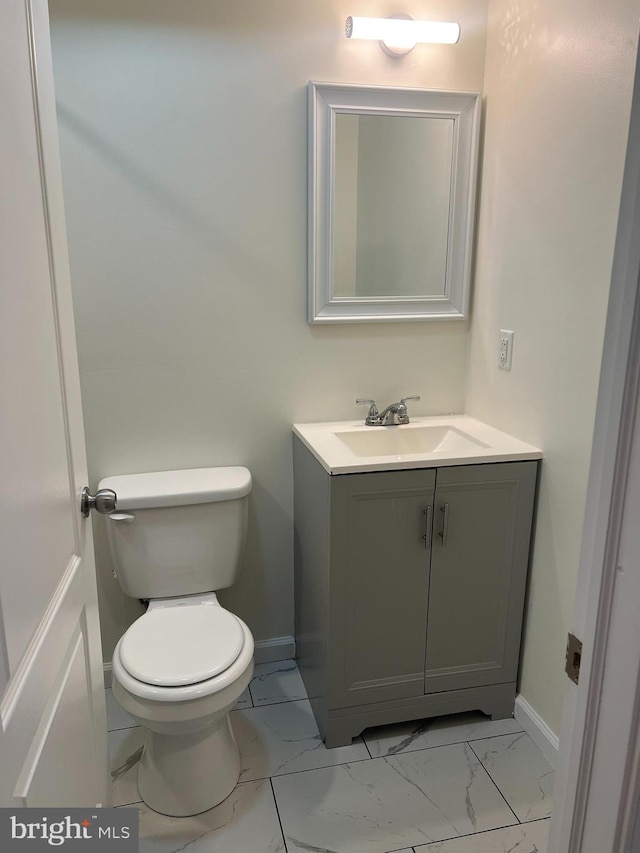 bathroom with tile patterned flooring, vanity, and toilet