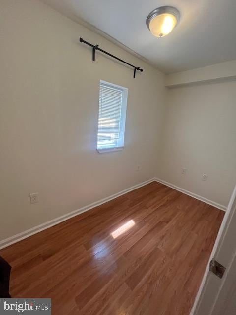 unfurnished room featuring hardwood / wood-style flooring