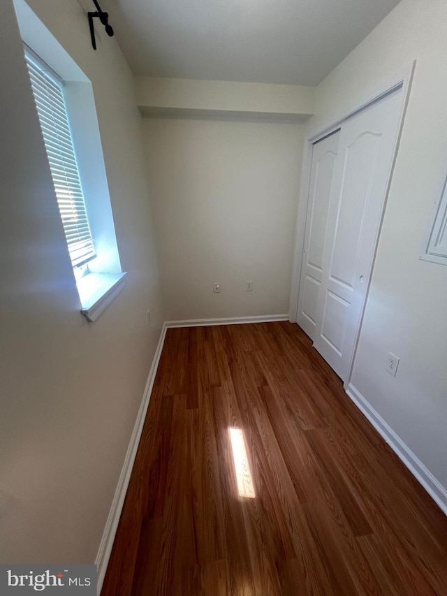 unfurnished bedroom featuring a closet and hardwood / wood-style floors