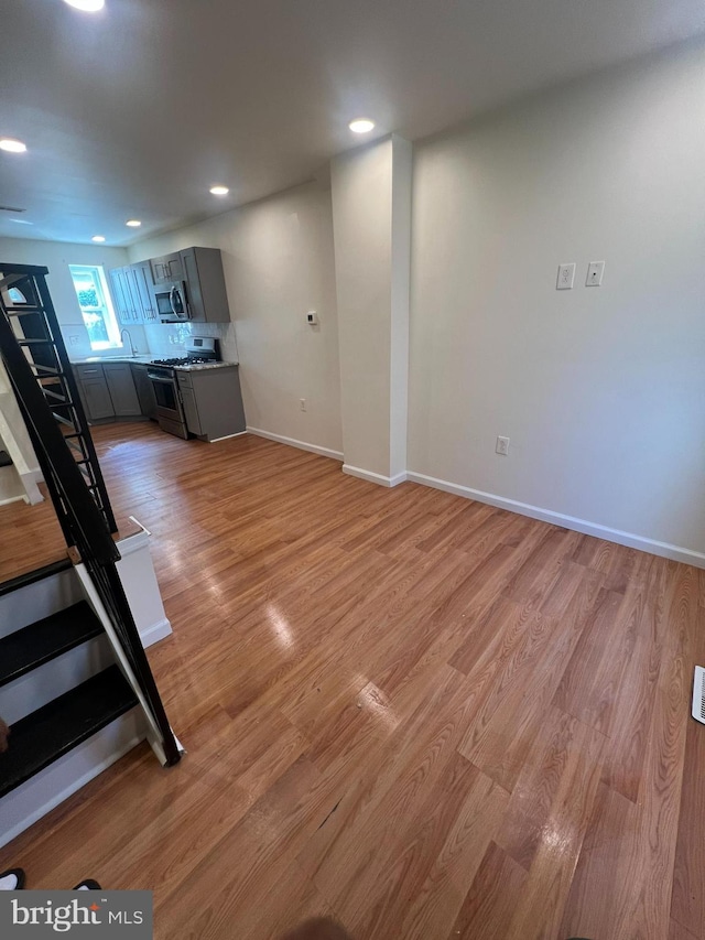 unfurnished living room featuring hardwood / wood-style floors