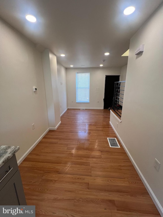 corridor with wood-type flooring