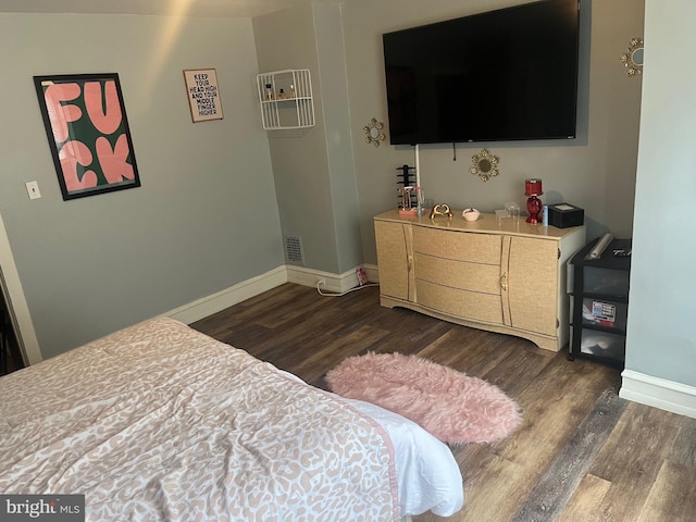 bedroom featuring dark hardwood / wood-style flooring