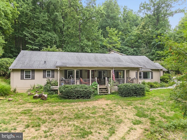 single story home with a porch and a front yard