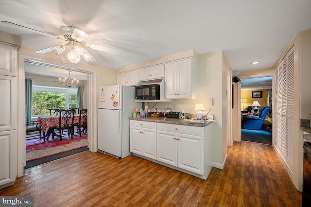 kitchen with white refrigerator, white cabinetry, ceiling fan with notable chandelier, and dark wood-type flooring