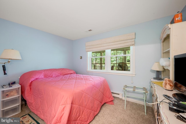 carpeted bedroom with a baseboard heating unit