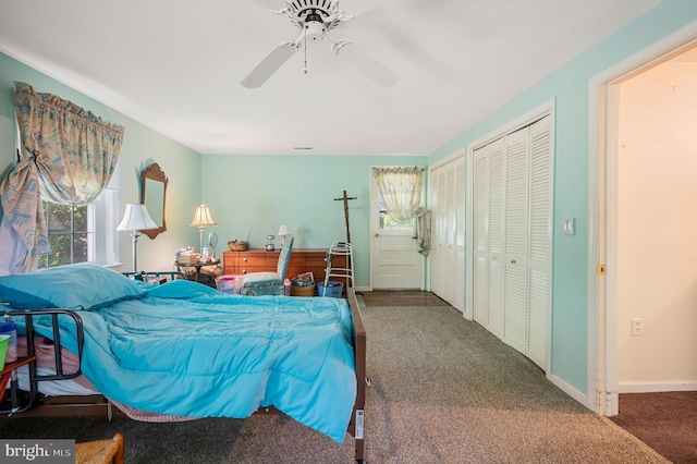 carpeted bedroom featuring ceiling fan and two closets