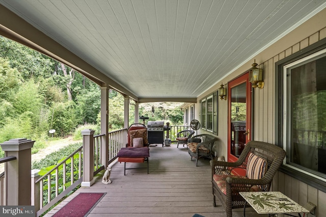 wooden deck with a grill and a porch