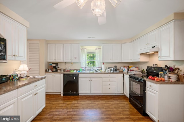 kitchen with sink, dark wood-type flooring, black appliances, and white cabinets