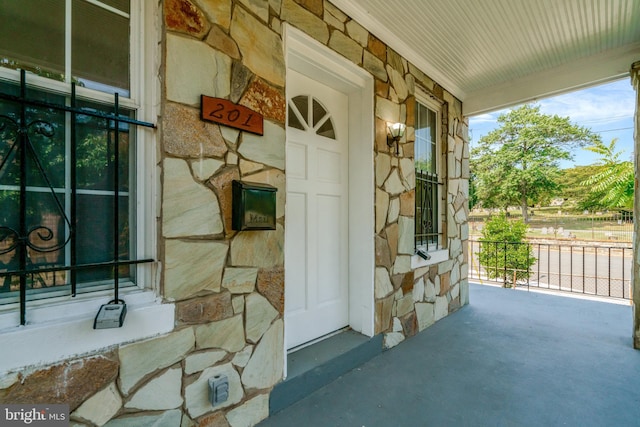 view of exterior entry with a porch