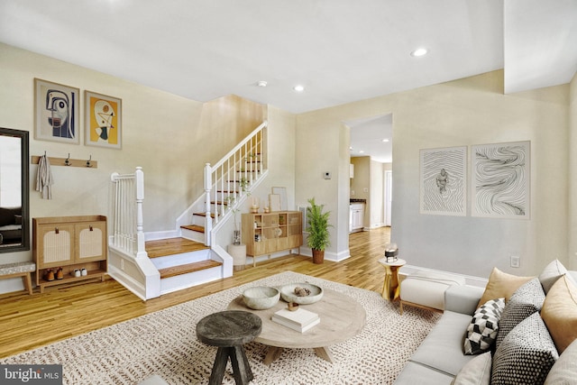 living area featuring stairs, baseboards, wood finished floors, and recessed lighting