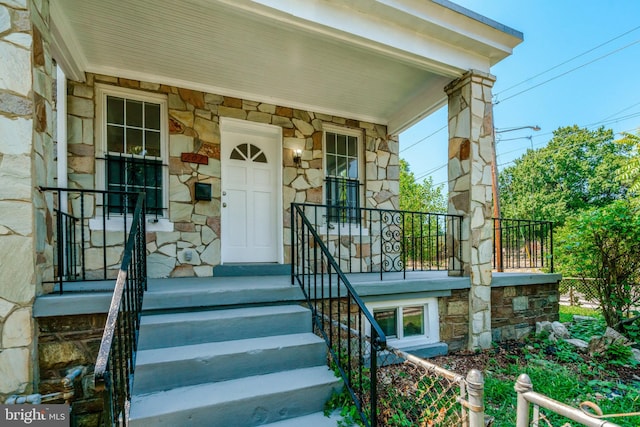 view of exterior entry with a porch