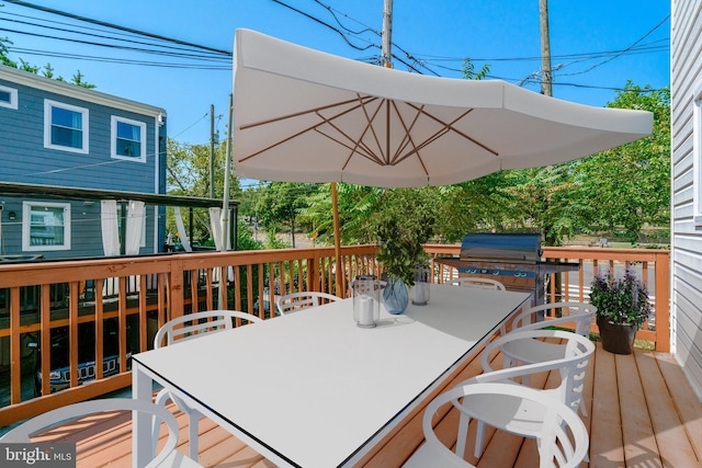 wooden deck with a grill and outdoor dining area